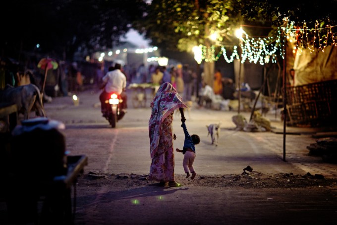 A woman is lifting her child on the streets of Oriya Basti, one of the nineteen water-affected colonies surrounding the abandoned Union Carbide (now DOW Chemical) industrial complex in Bhopal, Madhya Pradesh, India.