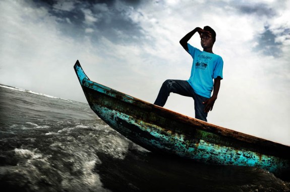 Monrovia, Liberia. Varney Parkir is 14 years old. Here he stands at the front of a boat. Parkir was born in Liberia and his mother died when he was a baby. His father couldn't provide for the family and his village doesn't have a school so he went to Monrovia, the capital, to go and live with his uncle. His father, stepmother and sister stayed behind in their village. Varney never goes to visit them. The people in the village were jealous of him so he doesn't feel welcome back home anymore. "I dream of becoming a captain of a big ship. With the ship I want to travel to Robertsport in Grand Cape Mount County. That's where I was born."